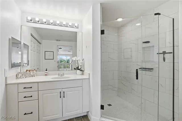 a bathroom with a shower sink and mirror