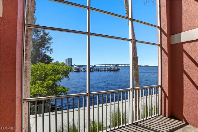 a view of a balcony with a floor to ceiling window and wooden fence