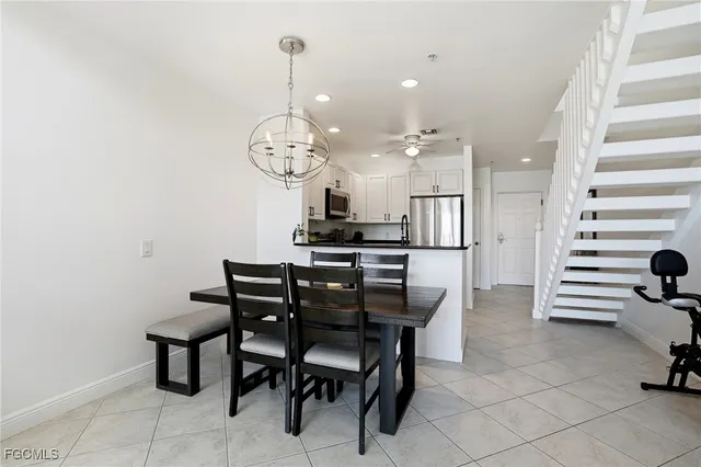 a view of a dining room with furniture and chandelier