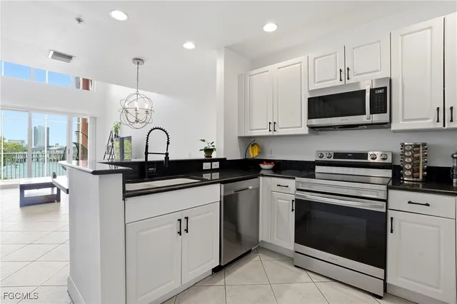 a kitchen with white cabinets and appliances