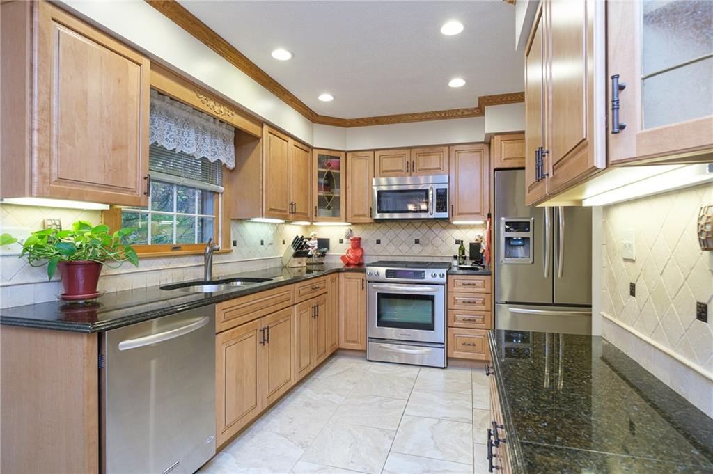 72 Midway Drive McKees Rocks, PA 15136 - Photo 3 of 25 a kitchen with stainless steel appliances granite countertop a refrigerator a stove and a sink