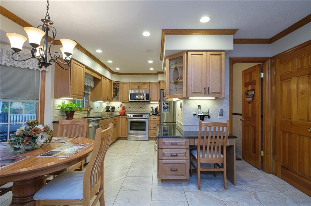 72 Midway Drive McKees Rocks, PA 15136 - Photo 4 of 25 a kitchen with refrigerator cabinets dining table and chairs