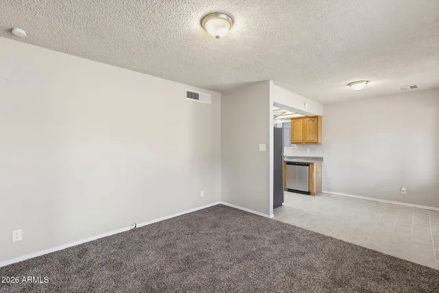 a kitchen with stainless steel appliances granite countertop a sink a refrigerator and a granite counter tops