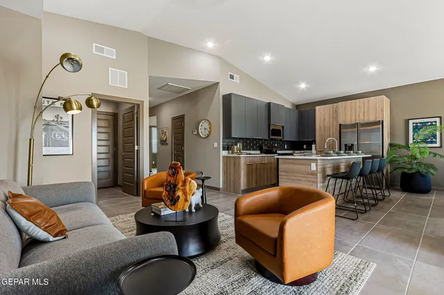 a living room with furniture kitchen and a window