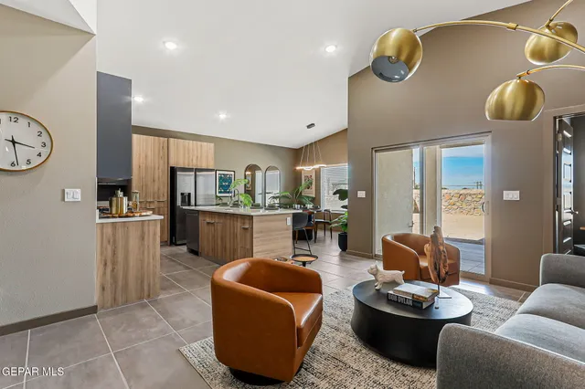 a living room with furniture and kitchen view