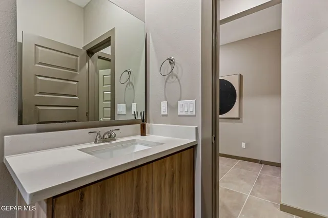 a bathroom with a sink vanity and mirror