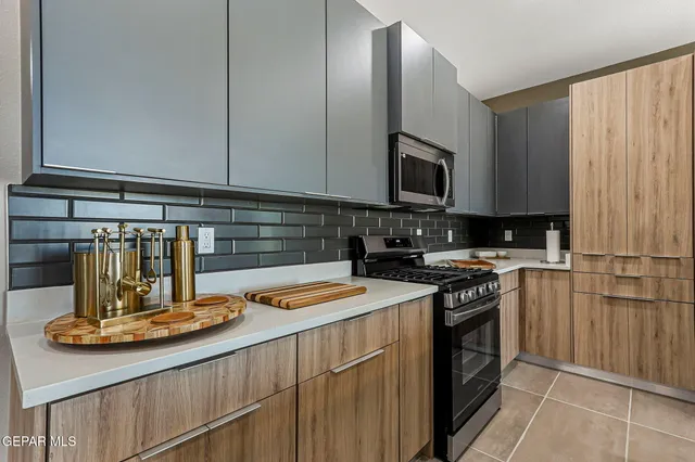 a kitchen with a sink stove and cabinets