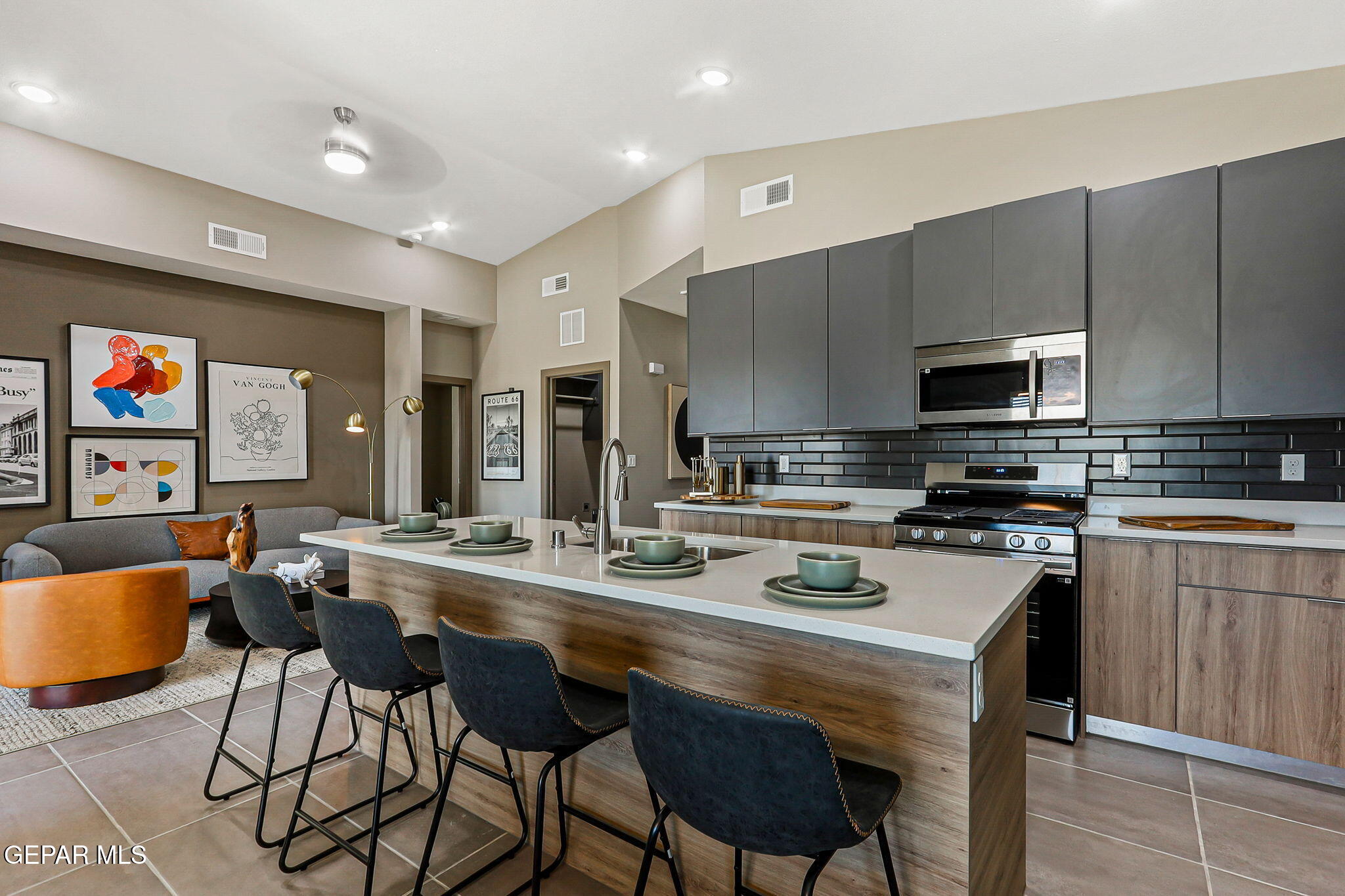 605 Espa Court Vinton, TX 79821 - Photo 6 of 31 a kitchen with stainless steel appliances a stove a sink a microwave a refrigerator and chairs