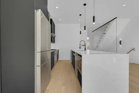 a kitchen with cabinets and stainless steel appliances