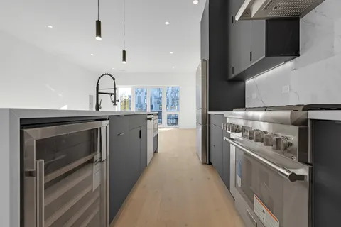 a kitchen with a stove and a refrigerator