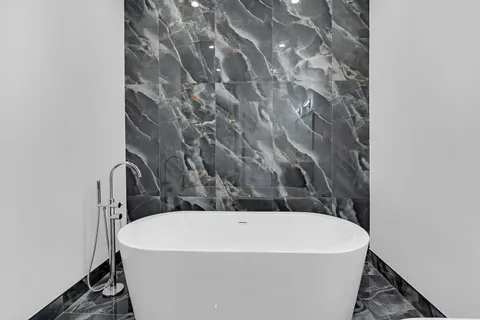 a white bath tub sitting in a bathroom