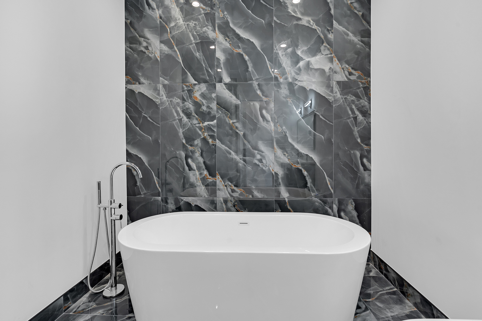 505 West Elm Street, Unit 7 Chicago, IL 60610 - Photo 23 of 36 a white bath tub sitting in a bathroom