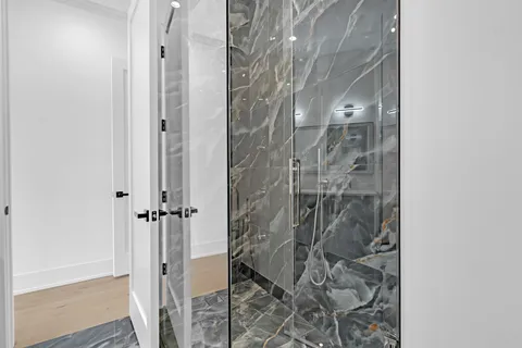 a bathroom with a glass shower door