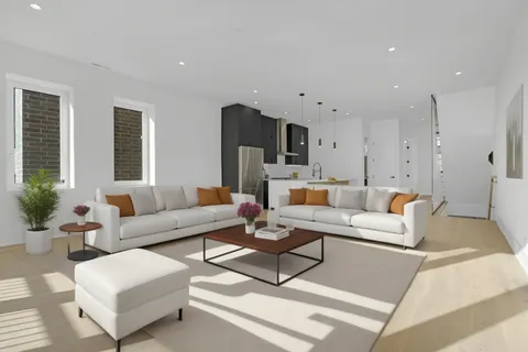 a living room with furniture a rug and a chandelier