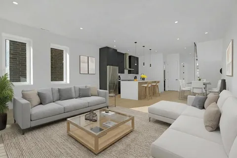 a living room with furniture kitchen and a table