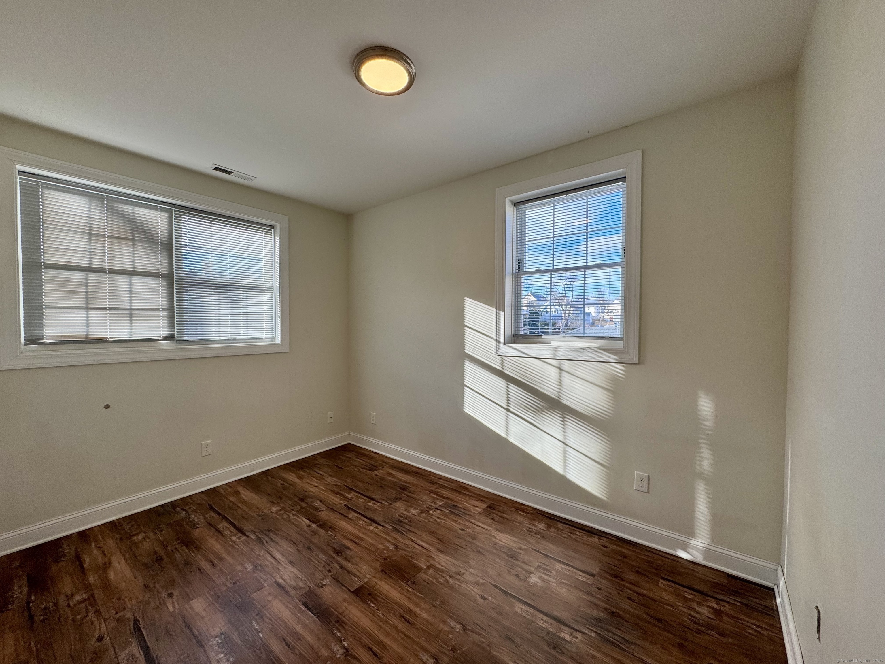 950 Lindley Street Bridgeport, CT 06606 - Photo 10 of 14 an empty room with wooden floor and windows