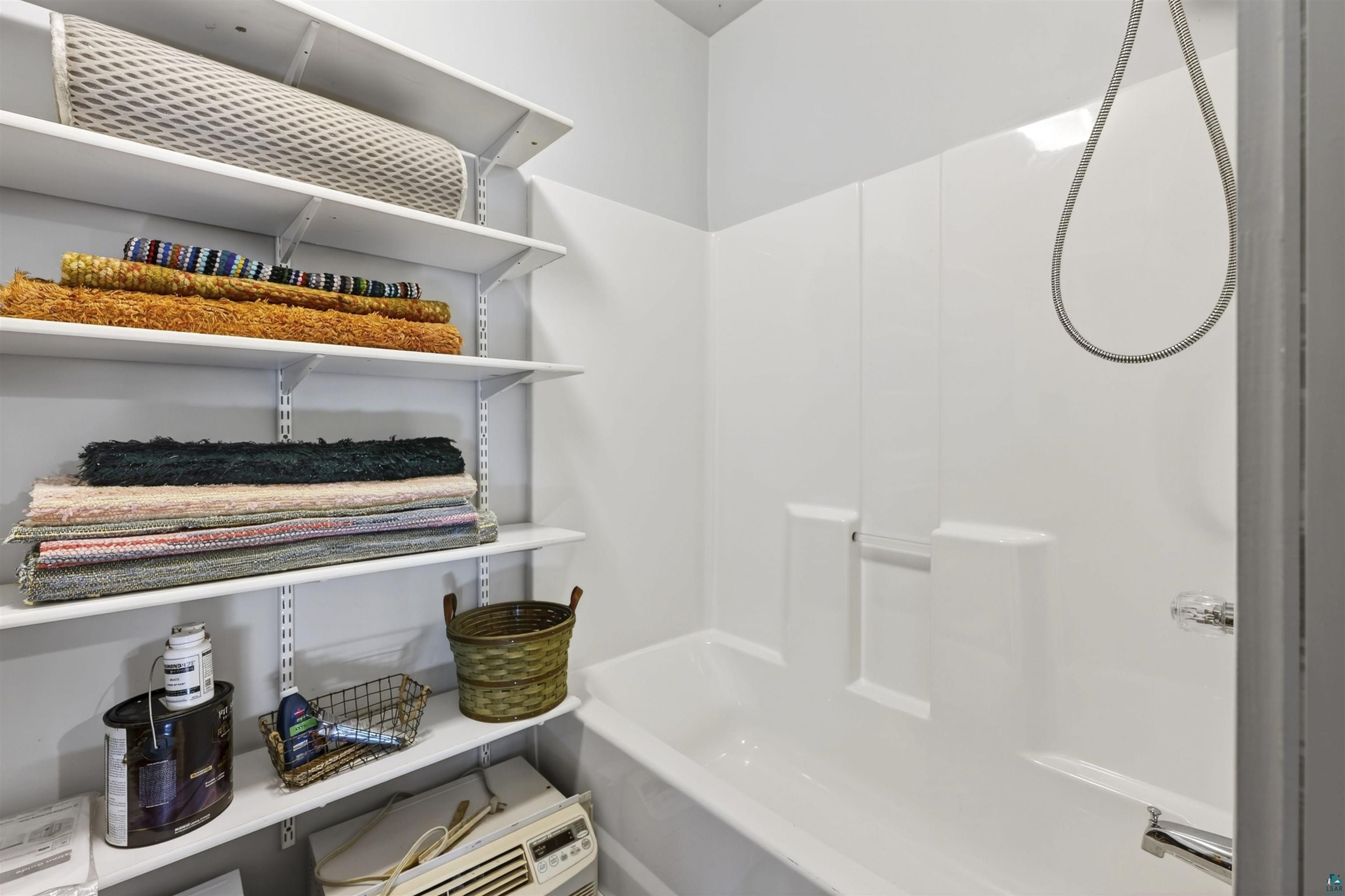 13885 Park Road Brule, WI 54820 - Photo 24 of 41 White tub and shower combination with chrome fixtures
