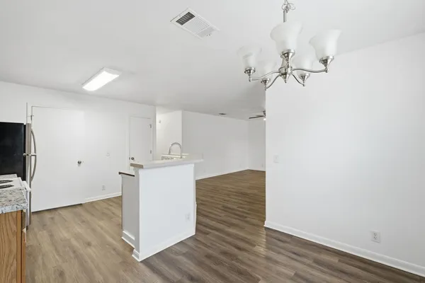 a kitchen with a refrigerator and a stove top oven
