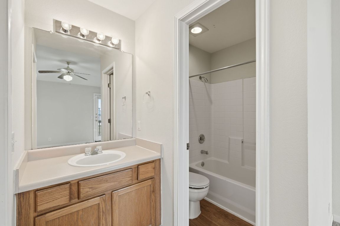 3201 E El Salido Parkway, Unit 511 Cedar Park, TX 78613 - Photo 8 of 12 Bathroom featuring vanity, washtub / shower combination, dark wood-type flooring, and ceiling fan