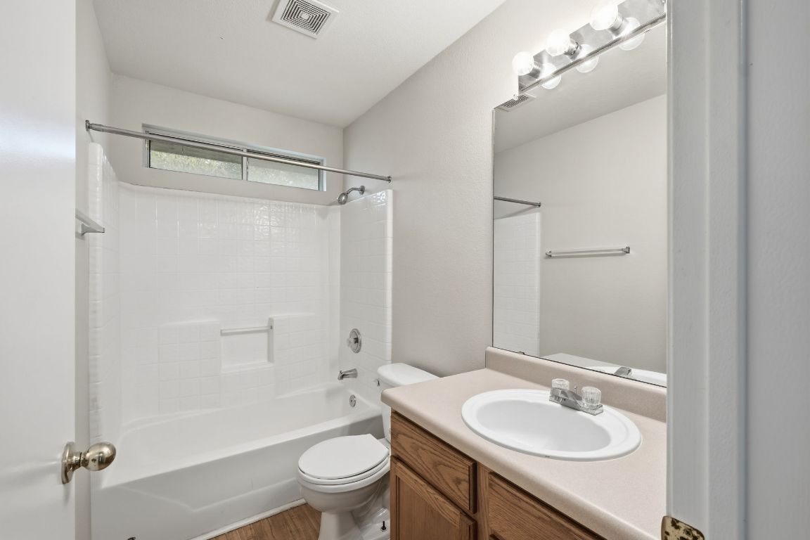 3201 E El Salido Parkway, Unit 511 Cedar Park, TX 78613 - Photo 10 of 12 Full bathroom with vanity, washtub / shower combination, and wood finished floors