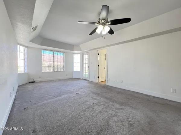 a view of a big room with closet and windows