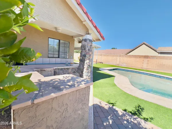 a view of an house with backyard space and balcony