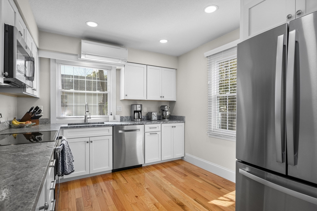 231 Route 28, Unit 20 Harwich, MA 02671 - Photo 7 of 22 a kitchen with a sink wooden floor and window