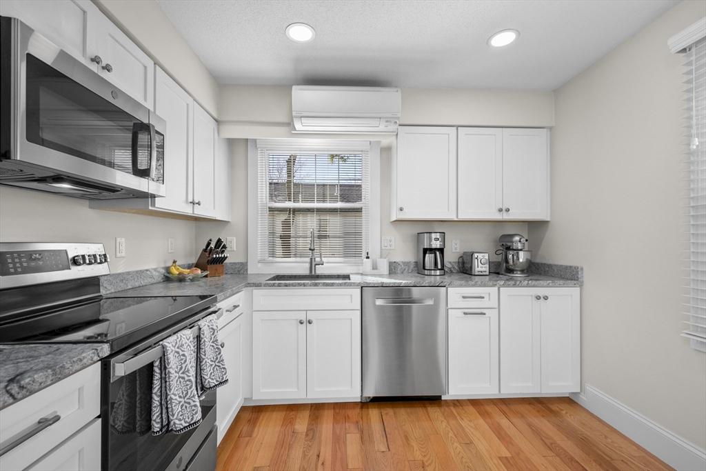 231 Route 28, Unit 20 Harwich, MA 02671 - Photo 8 of 22 a kitchen with stainless steel appliances granite countertop a sink stove and microwave