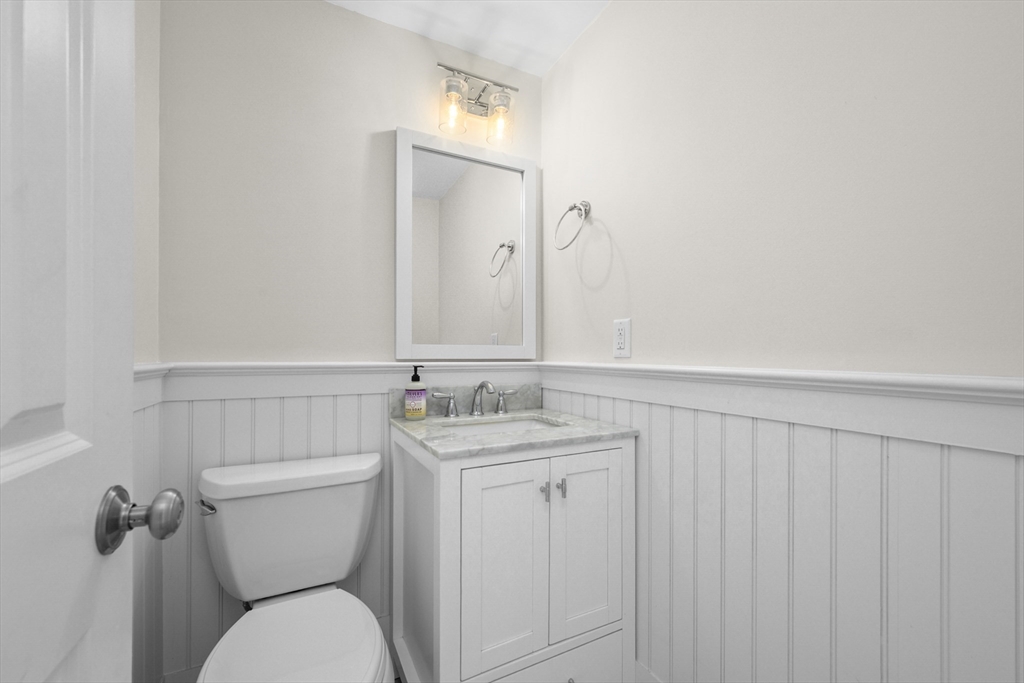 231 Route 28, Unit 20 Harwich, MA 02671 - Photo 10 of 22 a bathroom with a toilet a sink and mirror