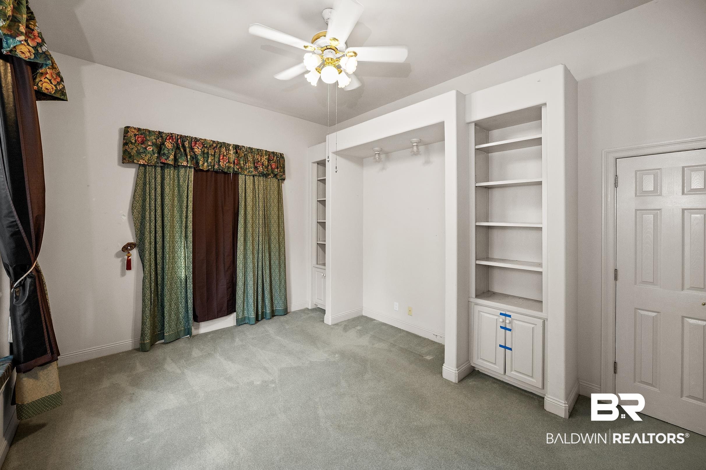 8591 Bay Harbor Road Elberta, AL 36530 - Photo 26 of 56 Unfurnished bedroom with light carpet and a ceiling fan