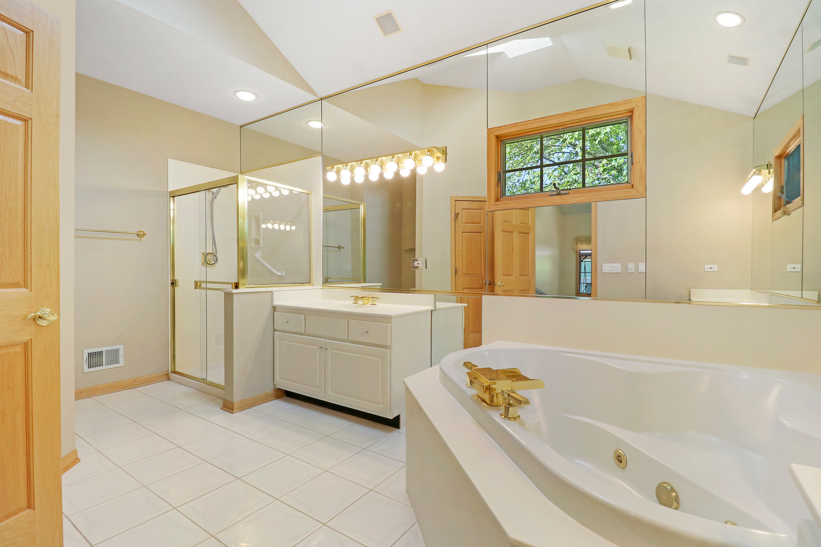 5551 Amanda Court Rolling Meadows, IL 60008 - Photo 12 of 27 a bathroom with a tub a sink a mirror and a shower
