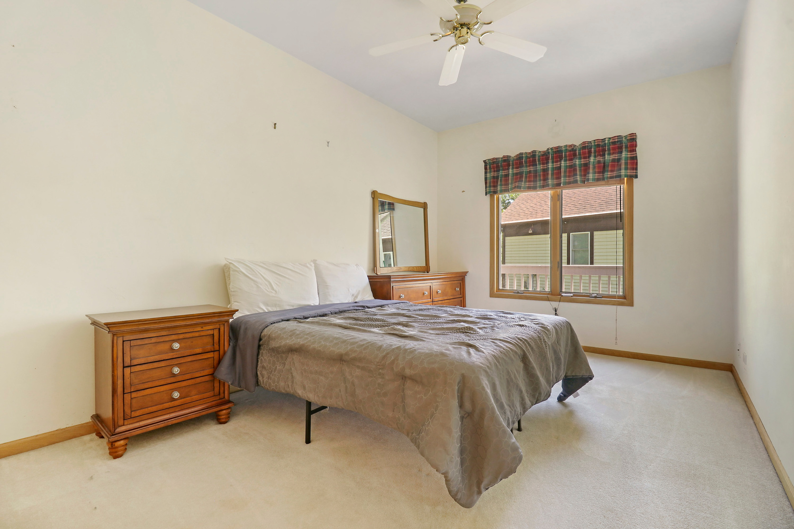 5551 Amanda Court Rolling Meadows, IL 60008 - Photo 13 of 27 a bedroom with a bed dresser and a window