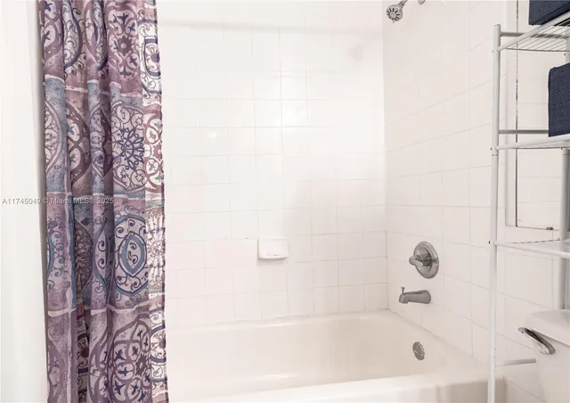 a bathroom with bathtub and shower