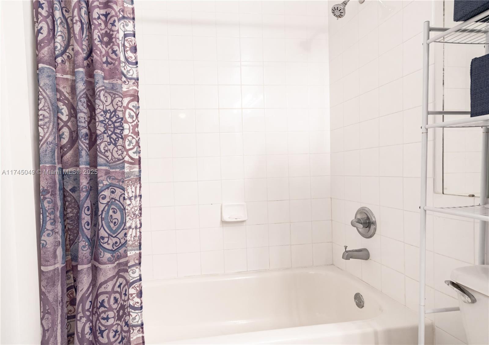 5091 Northwest 7th Street, Unit 1001 Miami, FL 33126 - Photo 12 of 17 a bathroom with bathtub and shower