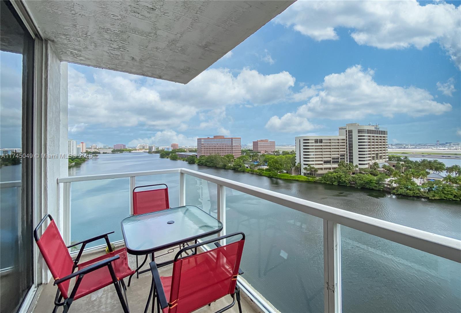 5091 Northwest 7th Street, Unit 1001 Miami, FL 33126 - Photo 3 of 17 a balcony with an outdoor seating