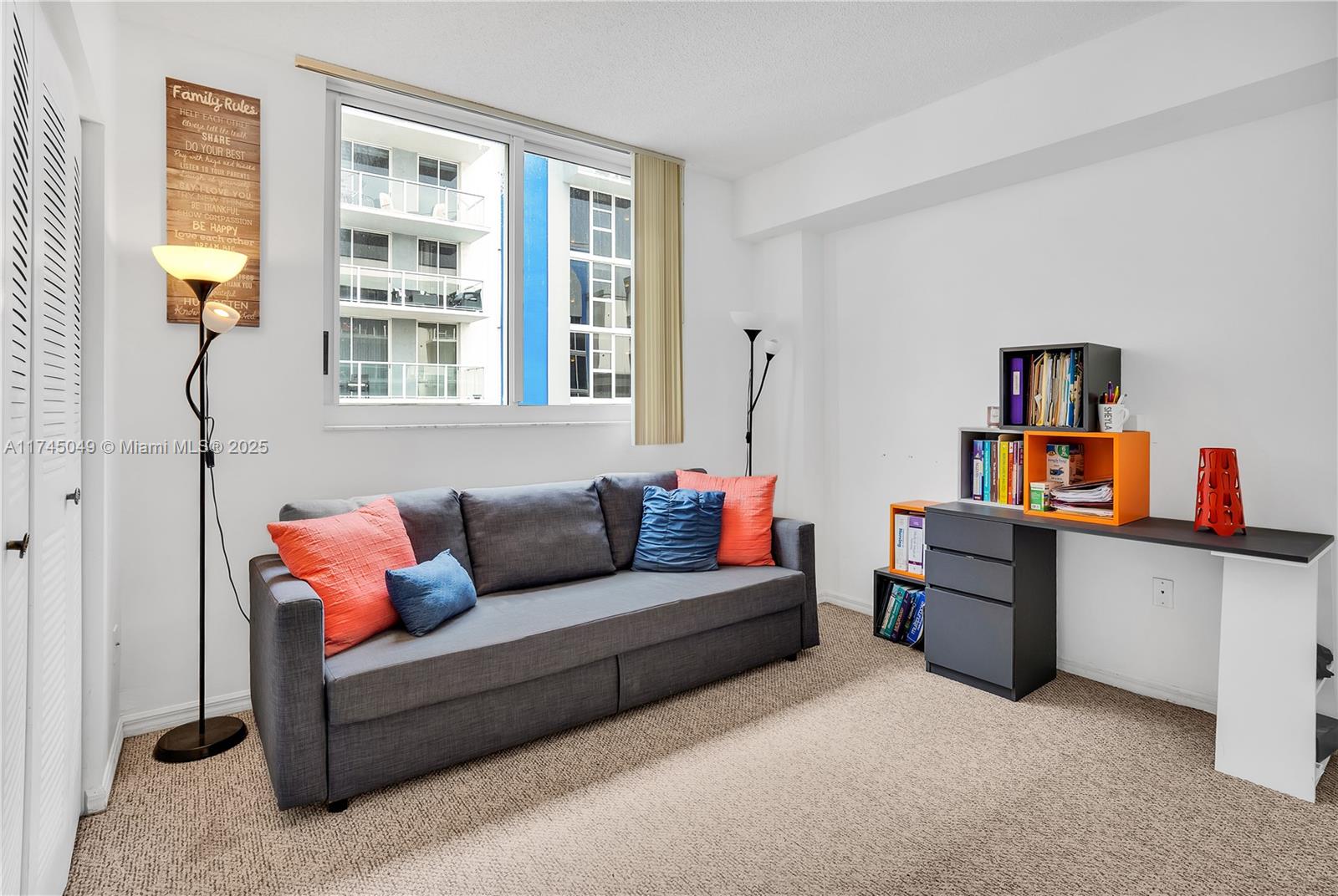 5091 Northwest 7th Street, Unit 1001 Miami, FL 33126 - Photo 10 of 17 a living room with furniture and a wooden floor