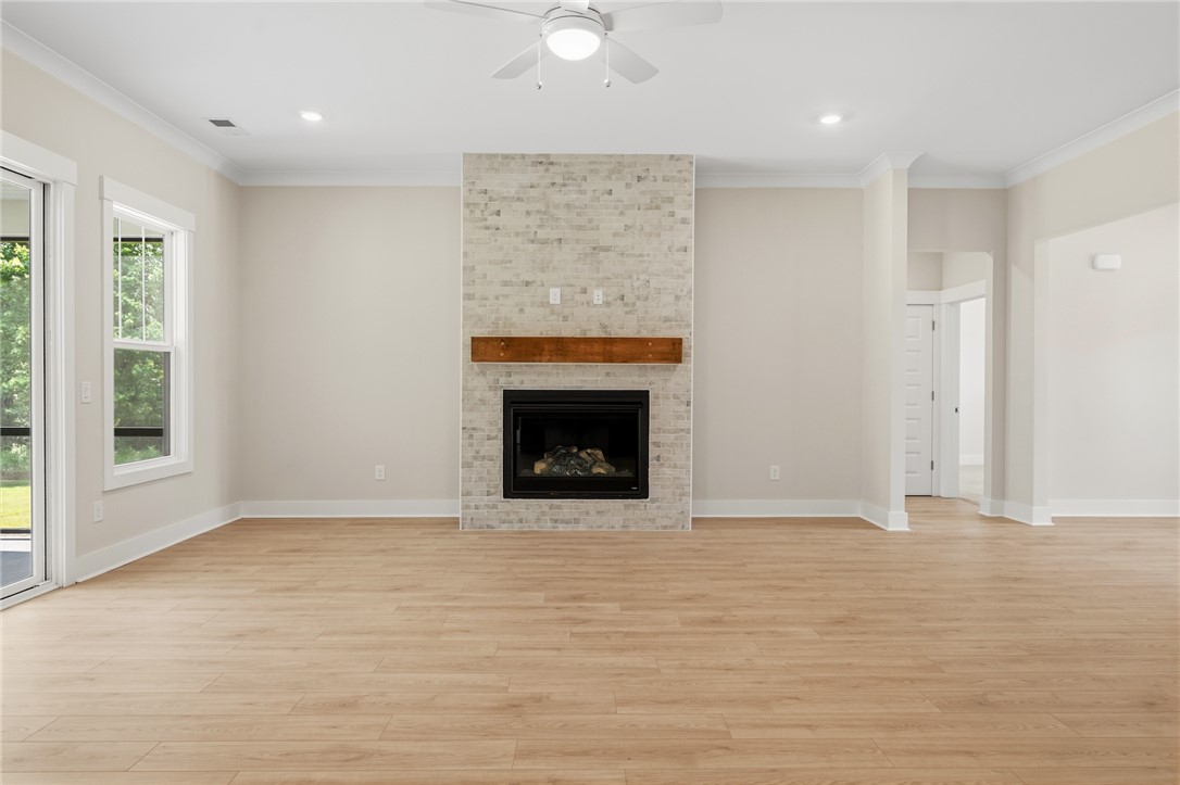 203 Timothy Court Anderson, SC 29621 - Photo 29 of 40 A chic living space featuring a brick-accented fireplace, wood mantel, and durable hardwood flooring.