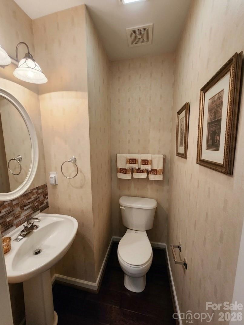 104 Rock Ridge Lane Mount Holly, NC 28120 - Photo 23 of 48 a bathroom with a toilet sink and mirror