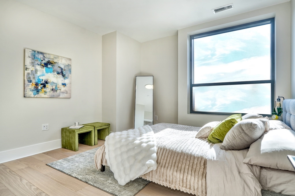62 Foundry Street, Unit 412 Wakefield, MA 01880 - Photo 15 of 32 a bedroom with a bed and a large window