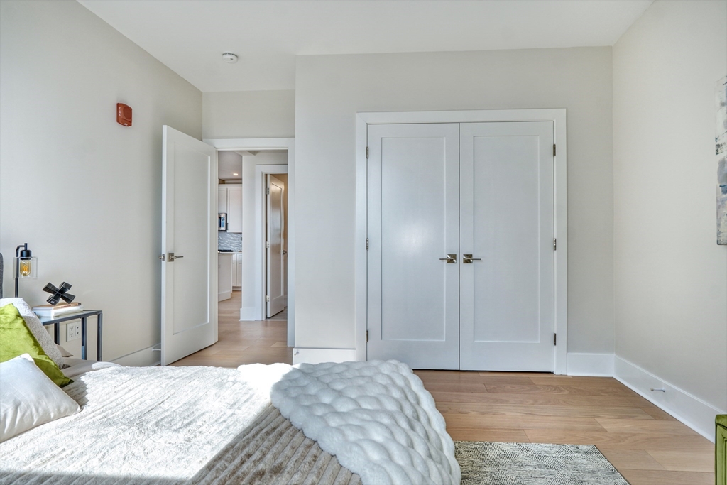 62 Foundry Street, Unit 412 Wakefield, MA 01880 - Photo 16 of 32 a bedroom with a bed and a table