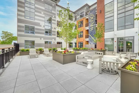 a view of a patio with dining table and chairs