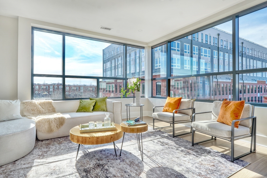 62 Foundry Street, Unit 412 Wakefield, MA 01880 - Photo 3 of 32 a living room with furniture and a large window