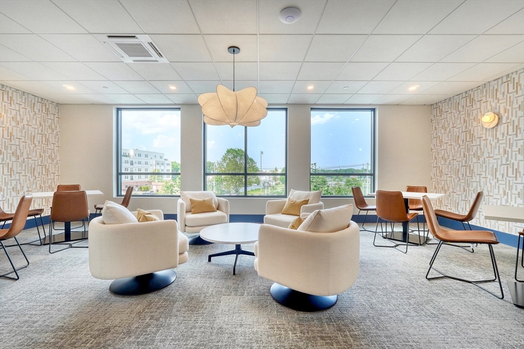 62 Foundry Street, Unit 412 Wakefield, MA 01880 - Photo 32 of 32 a living room with patio furniture and a large window