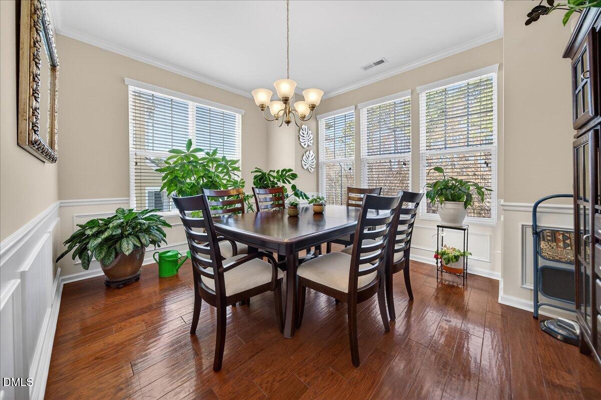 9328 Wooden Road Raleigh, NC 27617 - Photo 11 of 58 a view of a dining room with furniture window and wooden floor