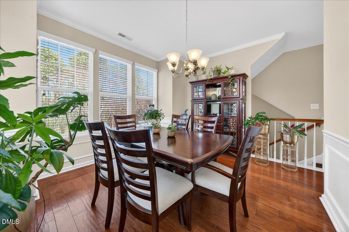 9328 Wooden Road Raleigh, NC 27617 - Photo 13 of 58 a view of a dining room with furniture window and wooden floor