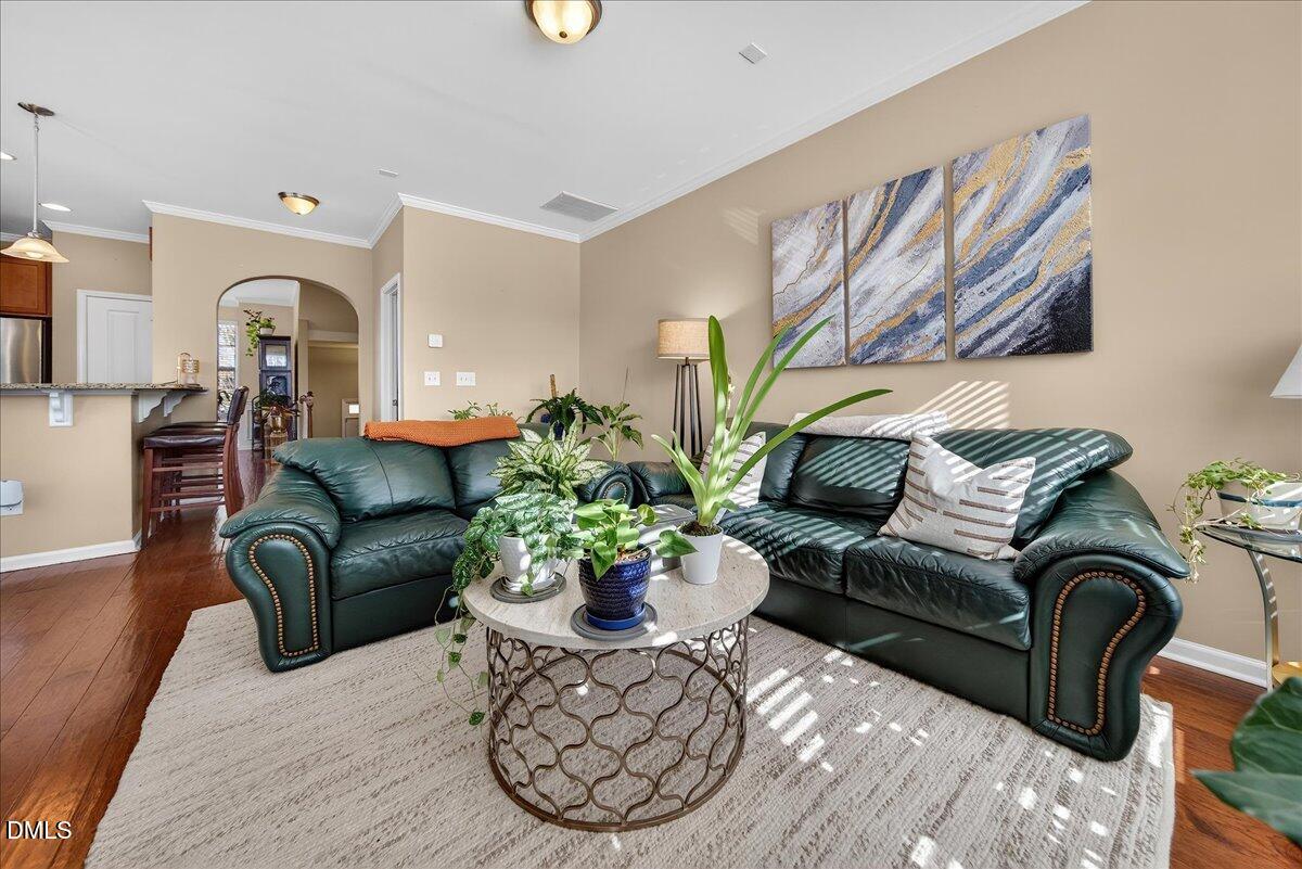 9328 Wooden Road Raleigh, NC 27617 - Photo 16 of 58 a living room with furniture flowerpot and wooden floor
