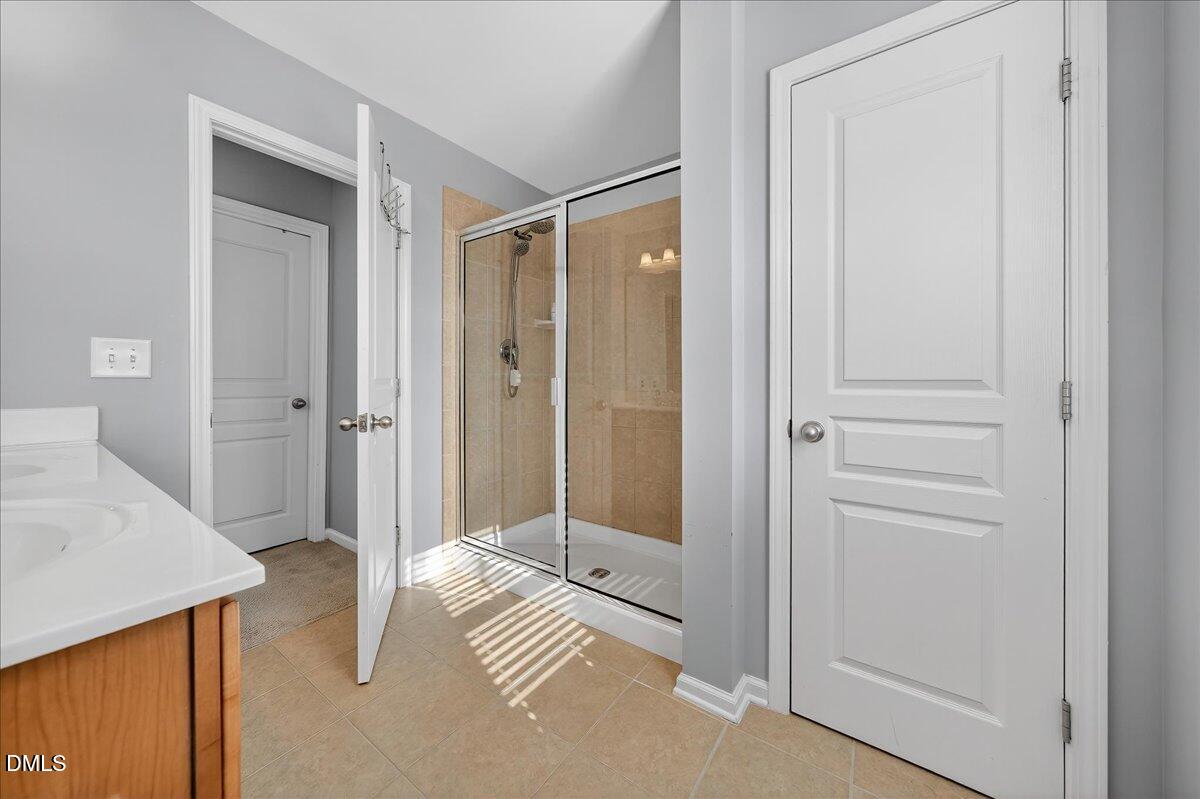 9328 Wooden Road Raleigh, NC 27617 - Photo 36 of 58 a bathroom with a shower and a sink