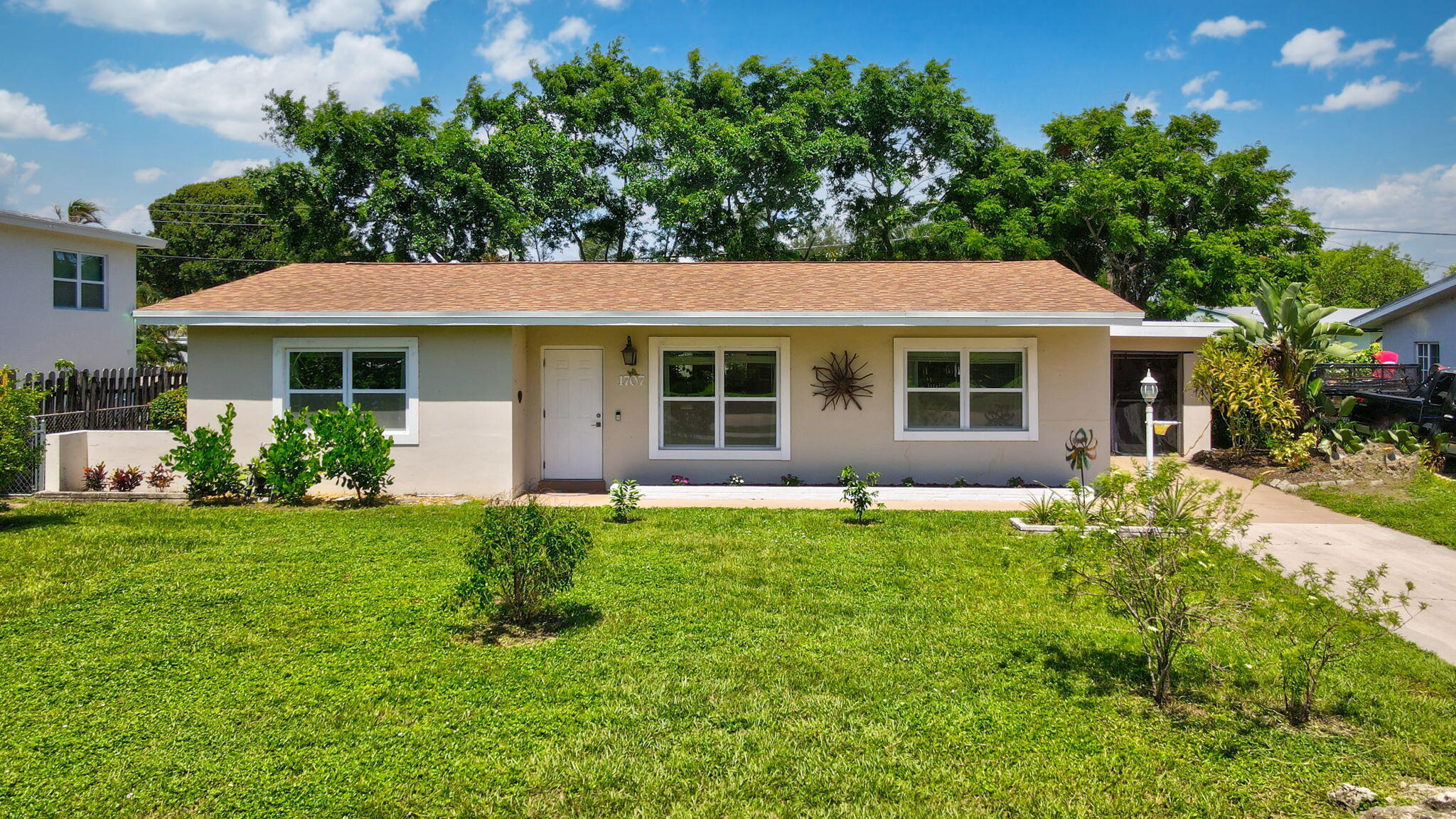 1707 High Ridge Road Lake Worth, FL 33461 - Photo 1 of 36 a house view with a garden space