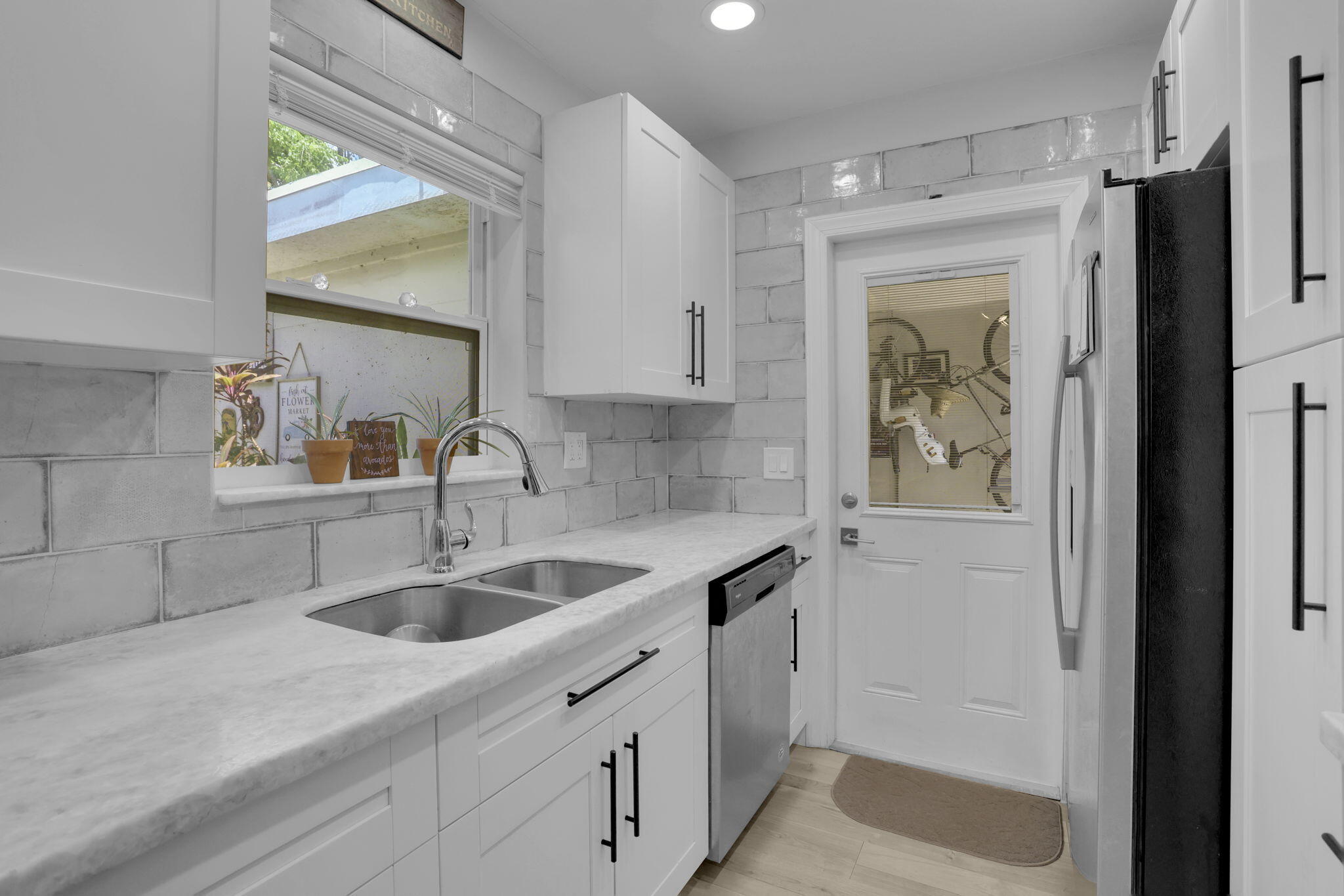 1707 High Ridge Road Lake Worth, FL 33461 - Photo 12 of 36 a kitchen with a sink and cabinets