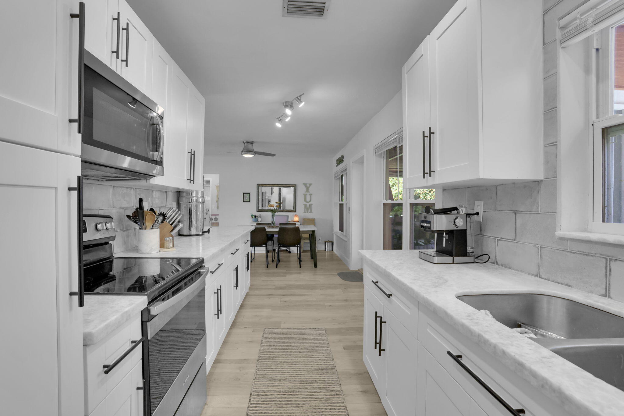 1707 High Ridge Road Lake Worth, FL 33461 - Photo 13 of 36 a large kitchen with stainless steel appliances lots of counter space and a sink